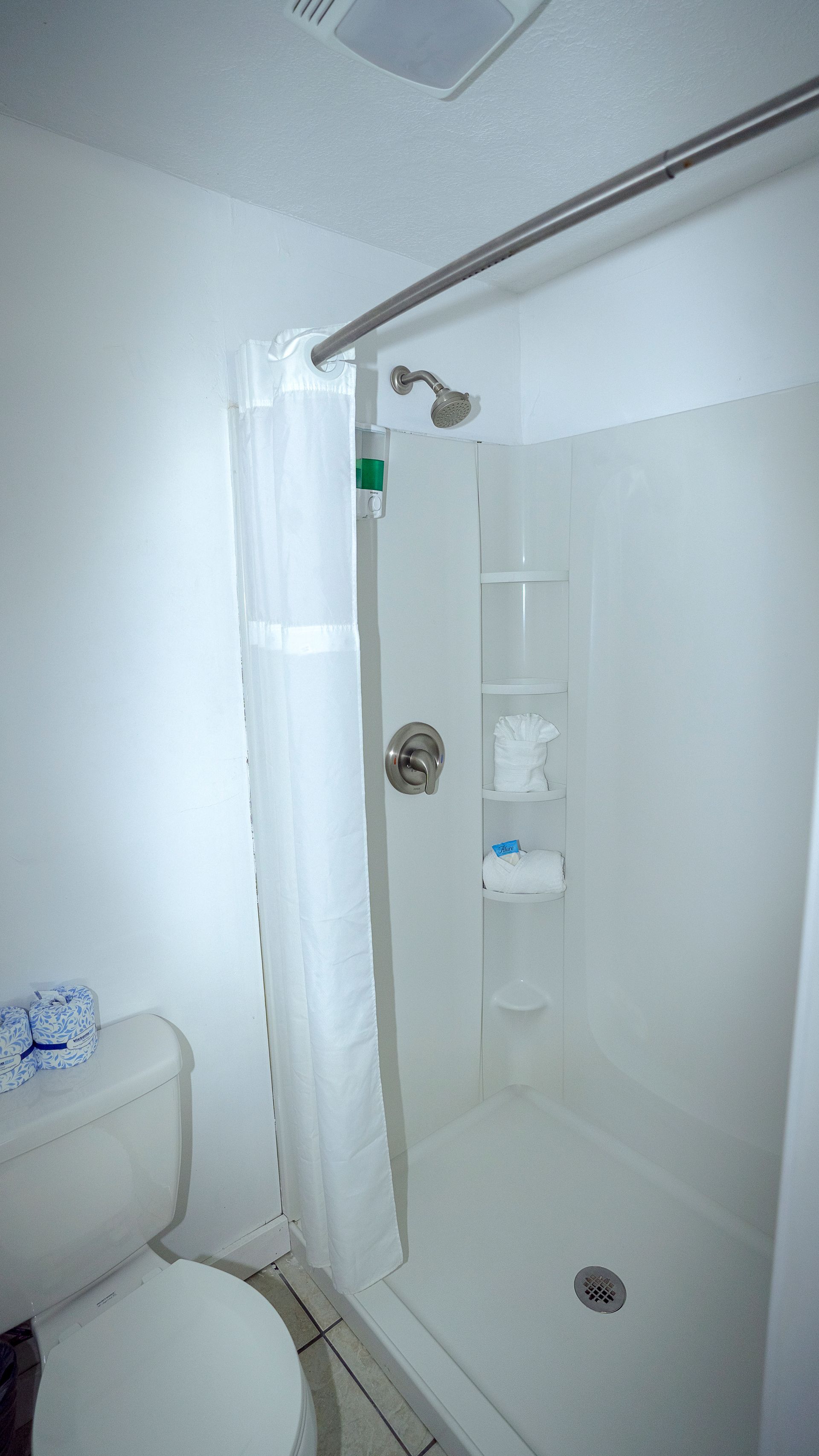 There is a toilet and a shower in the bathroom.