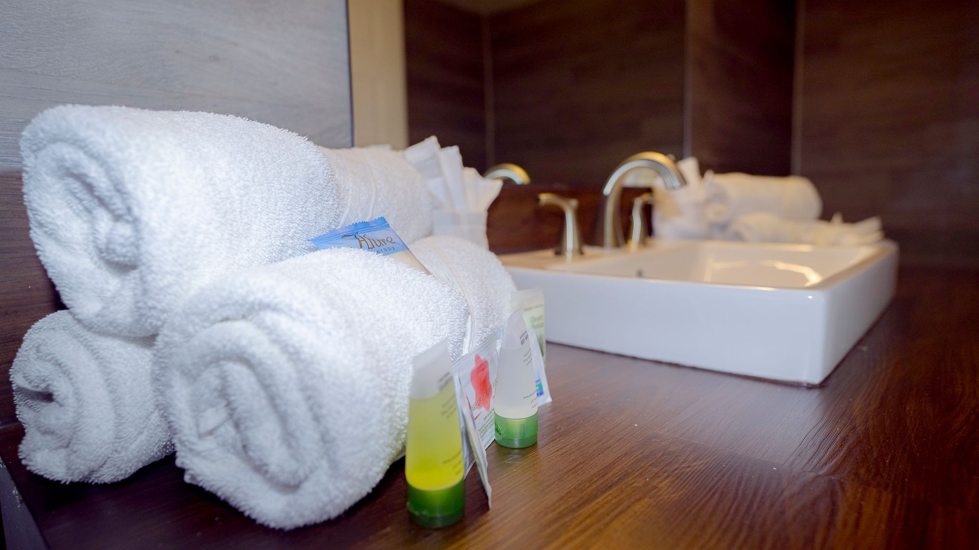A bathroom with a sink and towels on the counter.