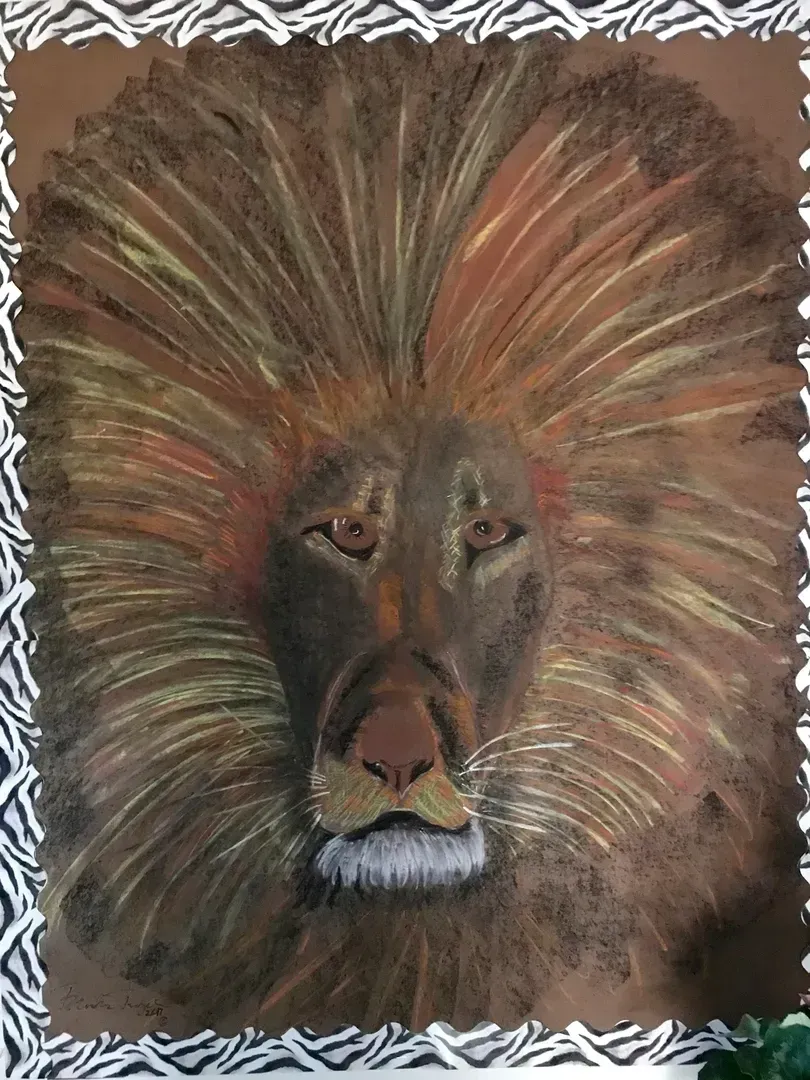 Close-up of a lion's face; brown and gold mane, focused gaze, brown background. Zebra patterned border.