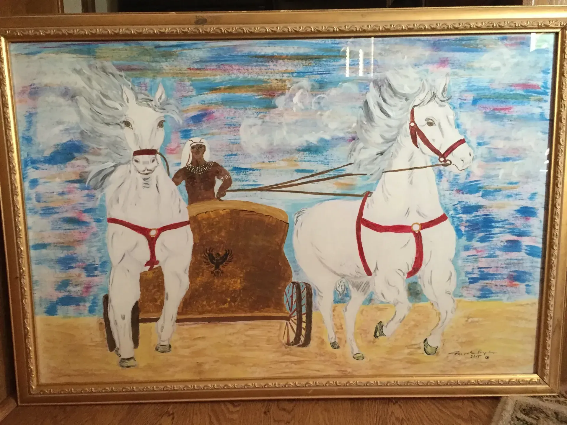 Chariot painting: white horses pull a chariot with a dark-skinned driver on a beach, beneath a blue sky.