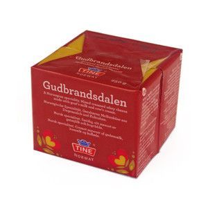 Norway's mountainous landscape, in which only about 3% of the land can be cultivated, made goat's cheese the more common in the past, but now the milk is often mixed with cow's to give a more varied taste. The result is a semi-hard cheese with a fat content lower than most (about 30%). However, it can be made with goat's milk alone, which is known as Ekte or genuine Gjetost.
It is made by boiling the leftover whey of cow's and goat's milk until the lactose caramelises (which gives it it's light brown appearance). The cheese is then poured into rectangular moulds and left to cool. The outer surface is similar to that of a decorated cake. The taste resembles a slightly sour but sweet caramel with a smooth texture similar to fudge. It can be shaven into thin slices and eaten with coffee for breakfast. At Christmas it is a favourite with spiced fruit cake. It is also considered ideal as a sweet fondue or a sauce for game. Mariners traditionally took this cheese with them on long voyages.