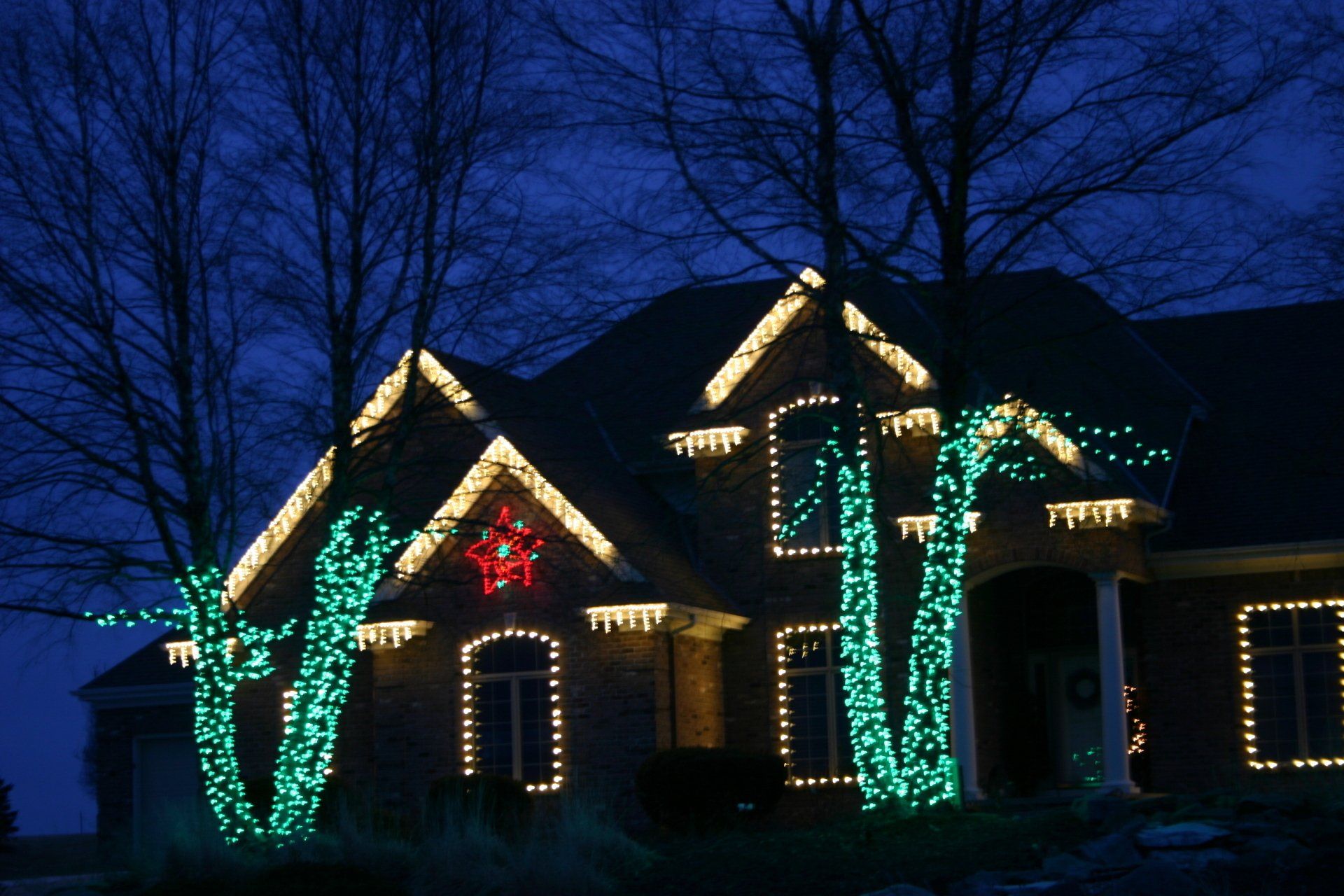 Custom Christmas lighting design on a large brick home in Eden Prairie, MN by Jingle Bulbs
