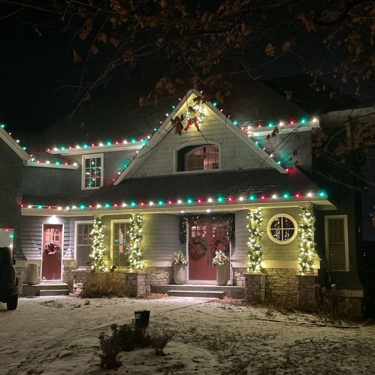 Subtle and elegant Christmas lighting on a lake-adjacent home in Woodland, MN
