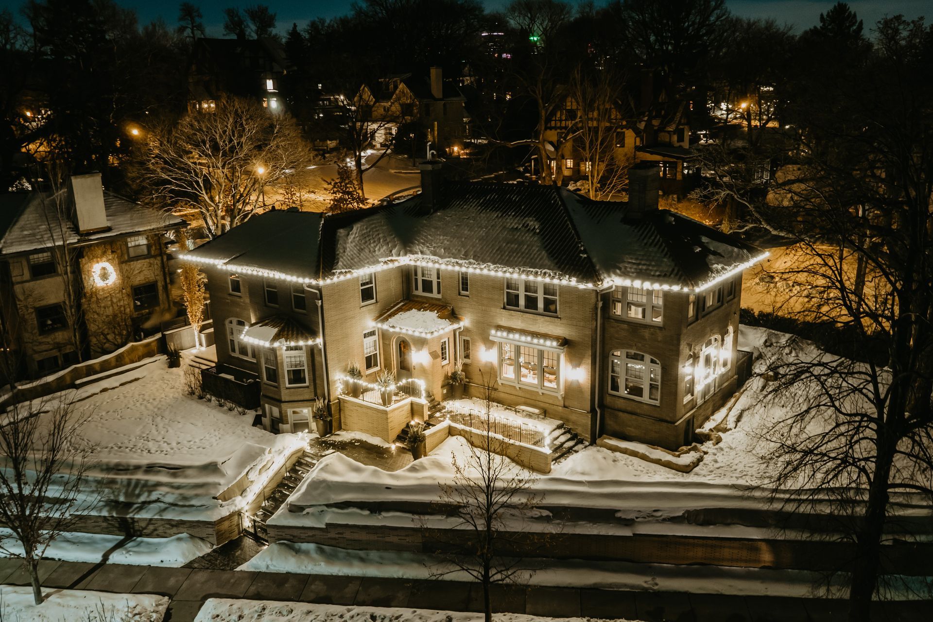 an aerial view of a house with christmas lights on it