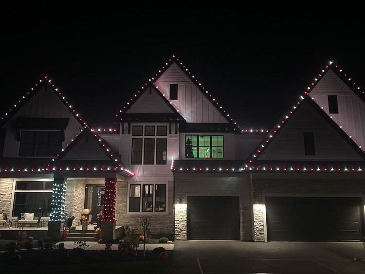 Warm holiday lights on a lakeside Prior Lake, MN home near The Wilds Golf Club