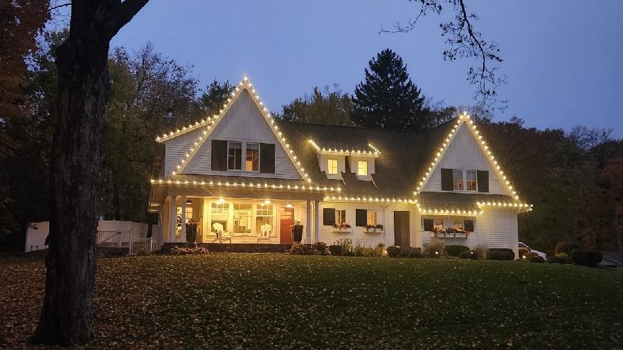 A large white house with christmas lights on it