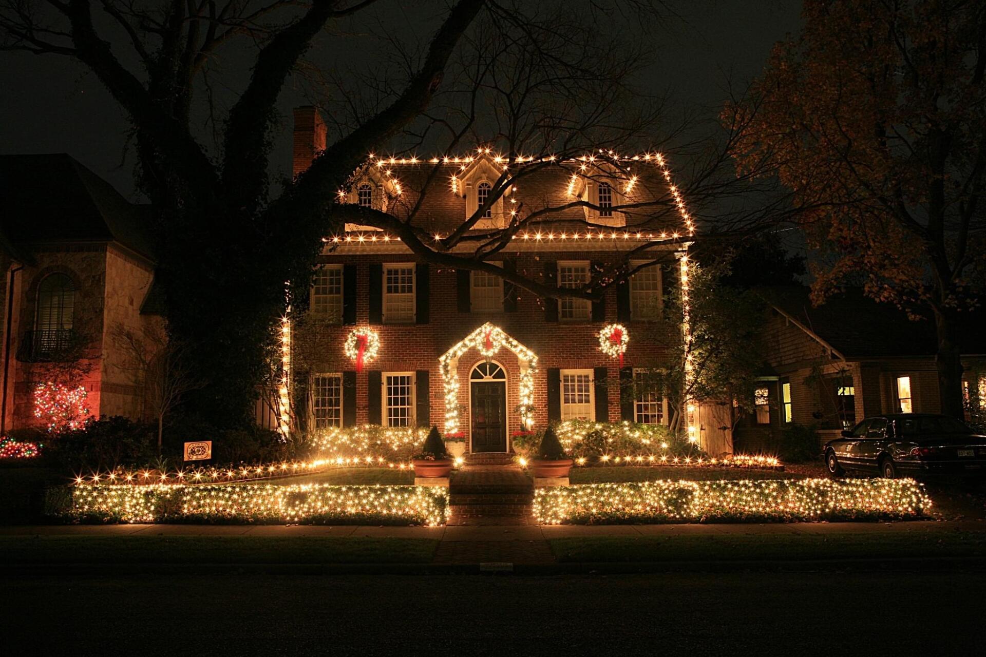 A house is decorated with christmas lights at night