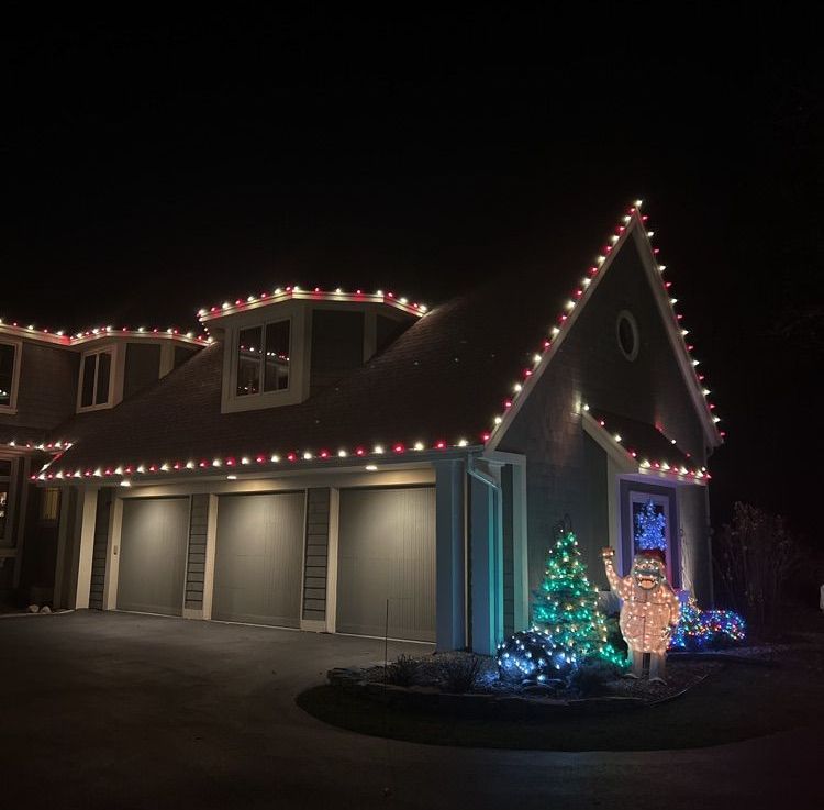 Warm white Christmas lights decorating a Corcoran, MN farmhouse roofline by Jingle Bulbs