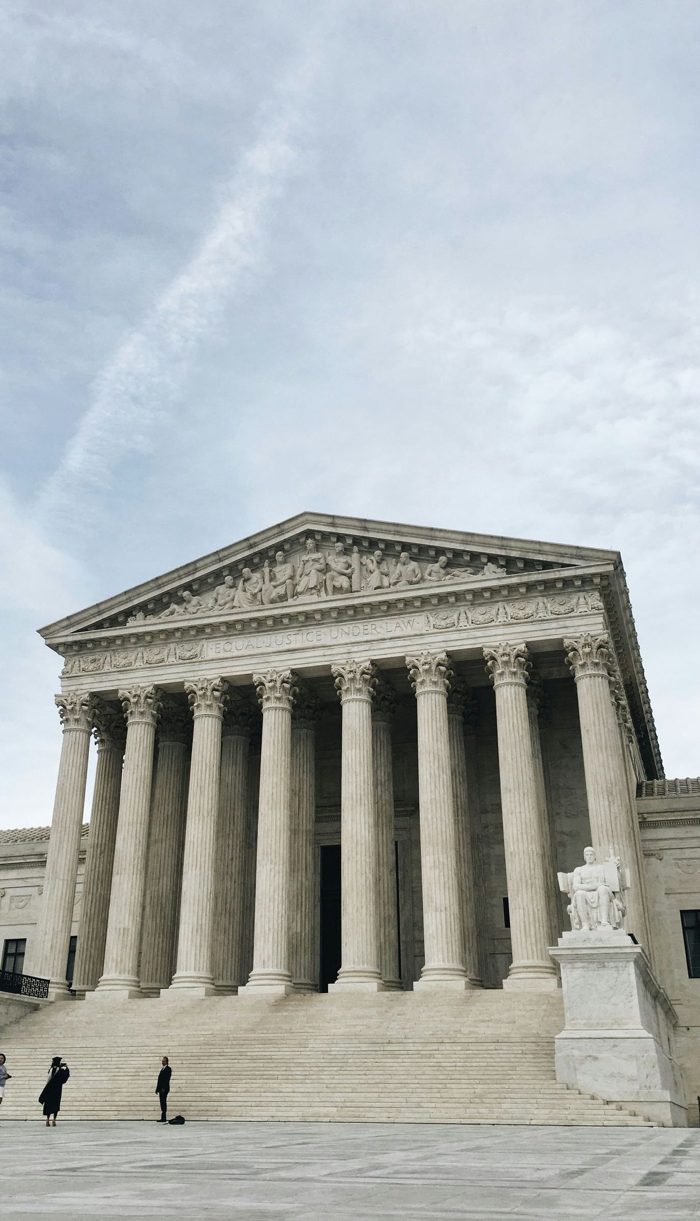 the supreme court building in washington d.c. is a very large building with columns and stairs 