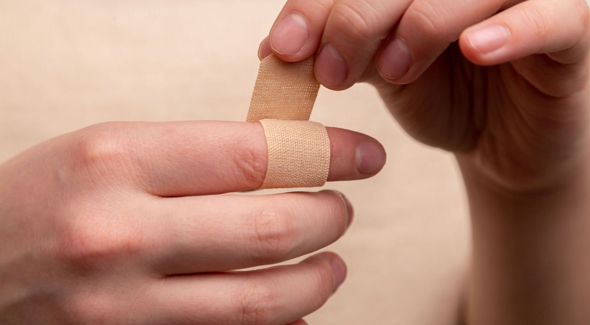 person putting on a bandaid