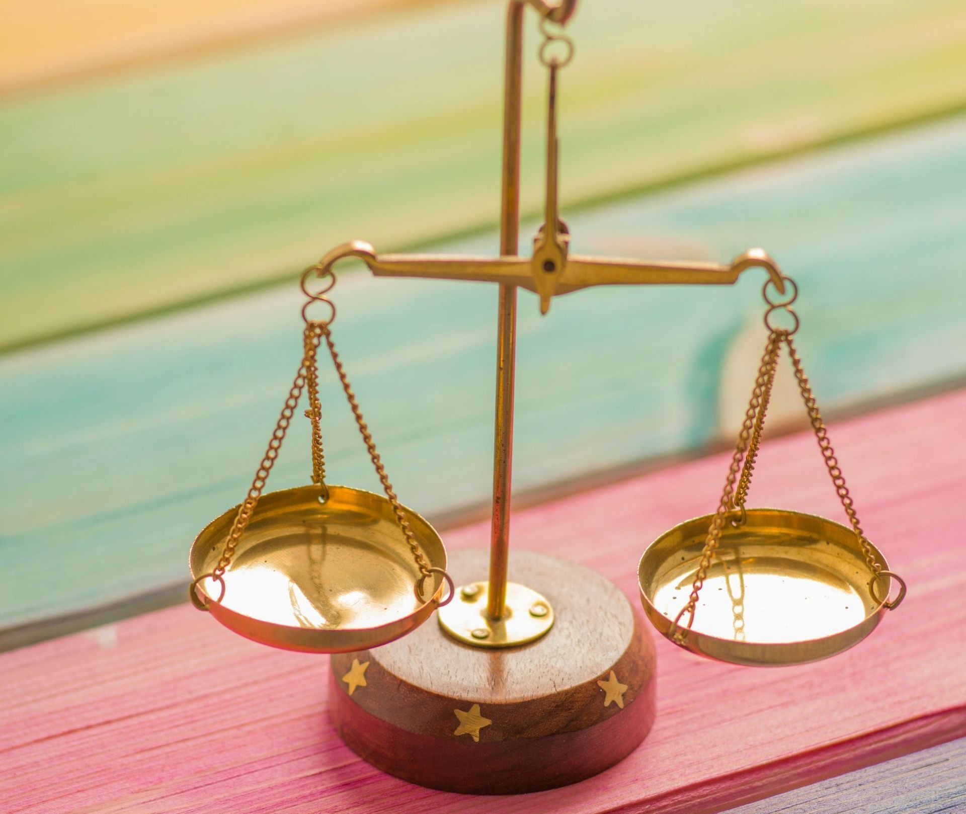 a brass scale with a wooden base and stars on it