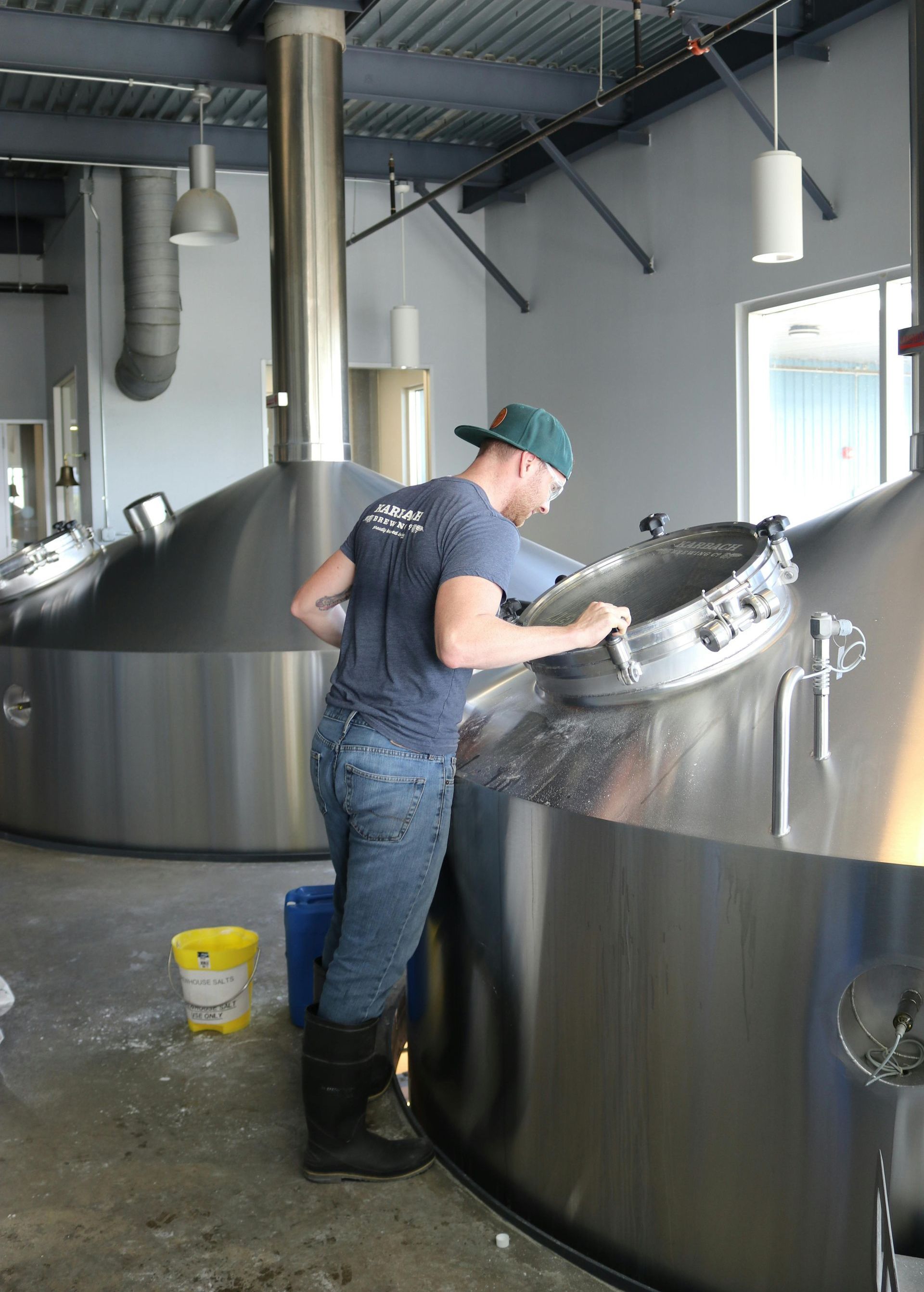 A man in a blue shirt is working in a brewery