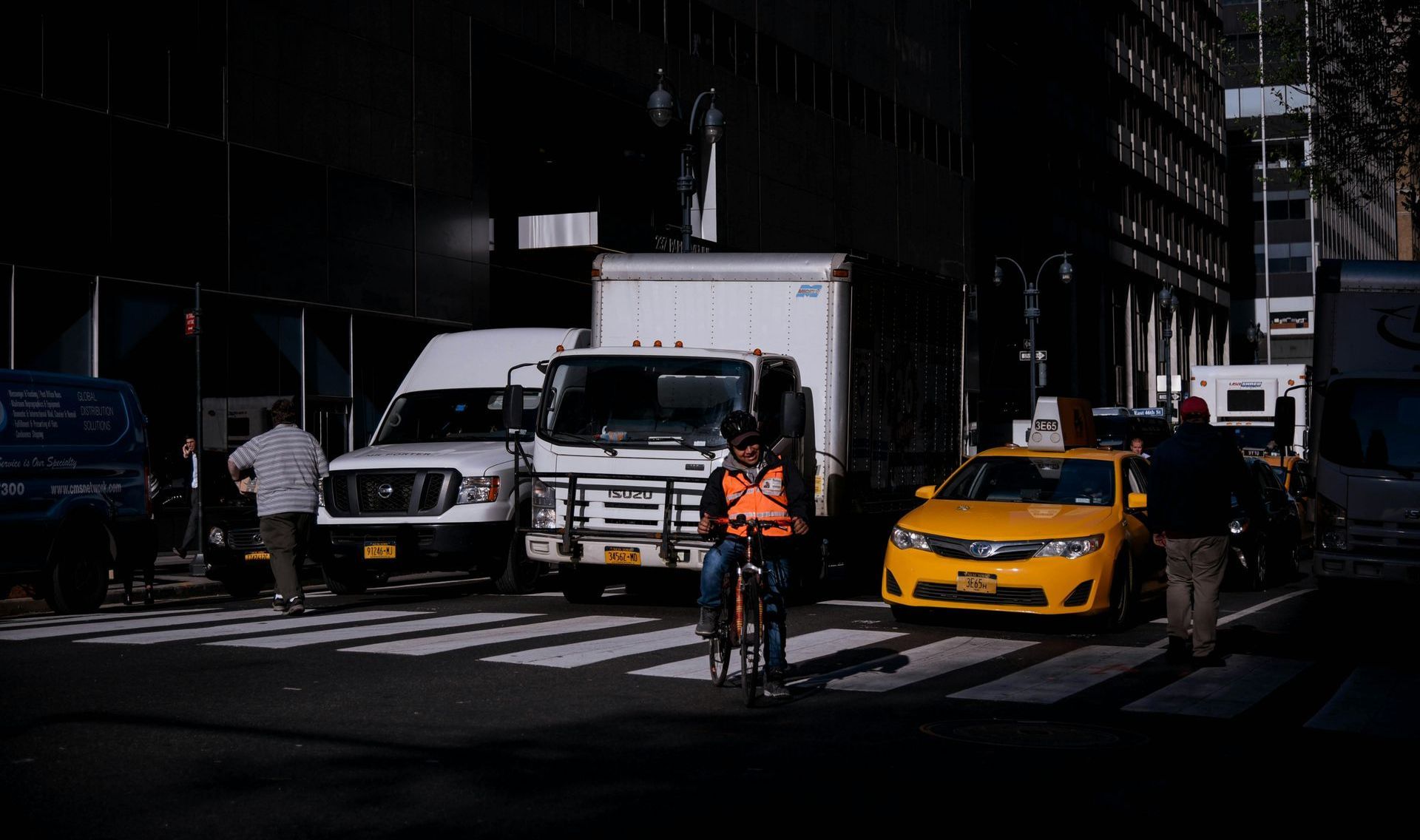 A man is riding a bike on a city street.