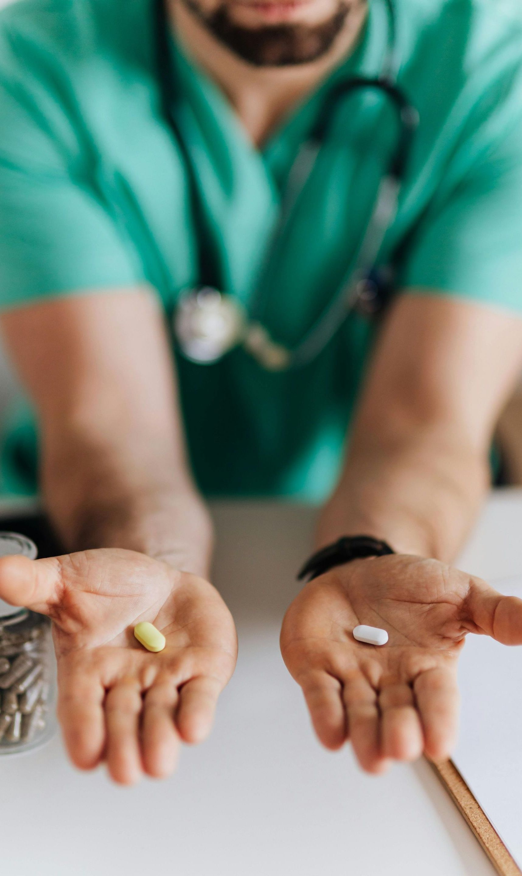 doctor holding two pills