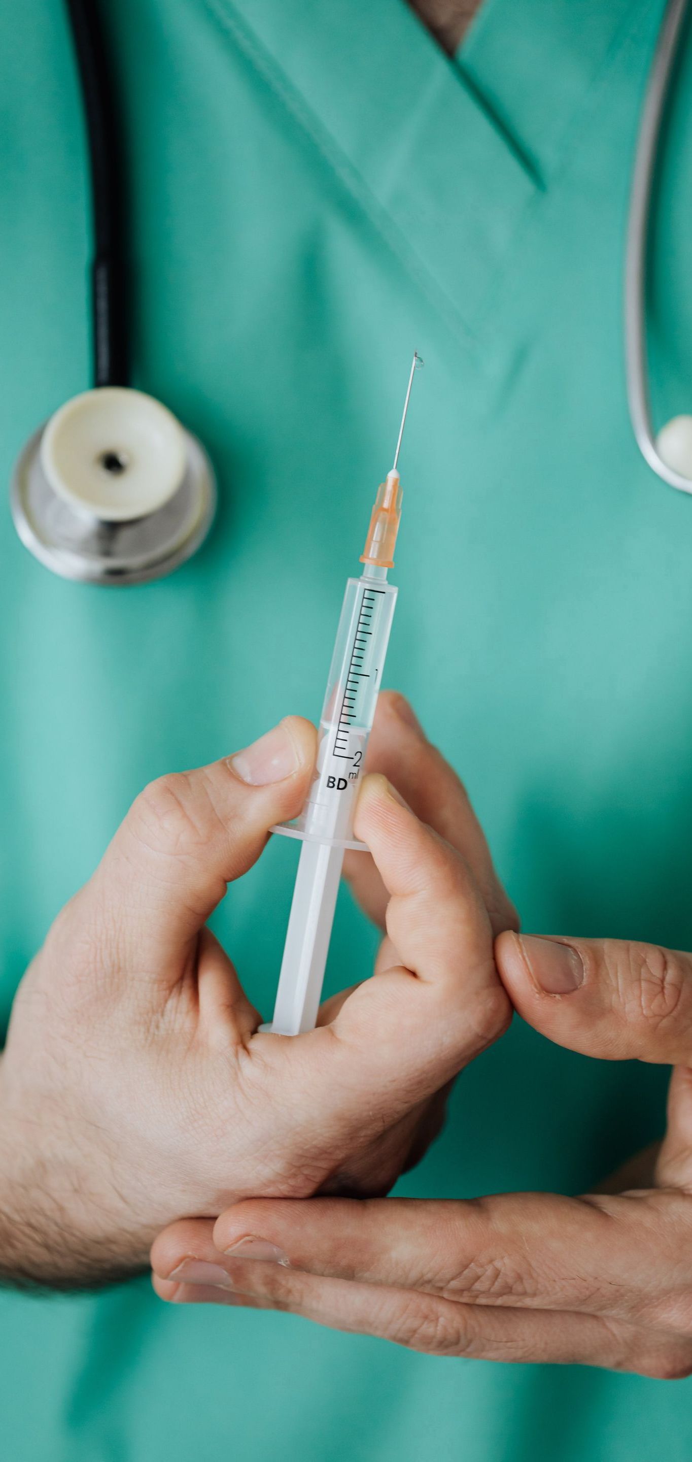 doctor holding injection