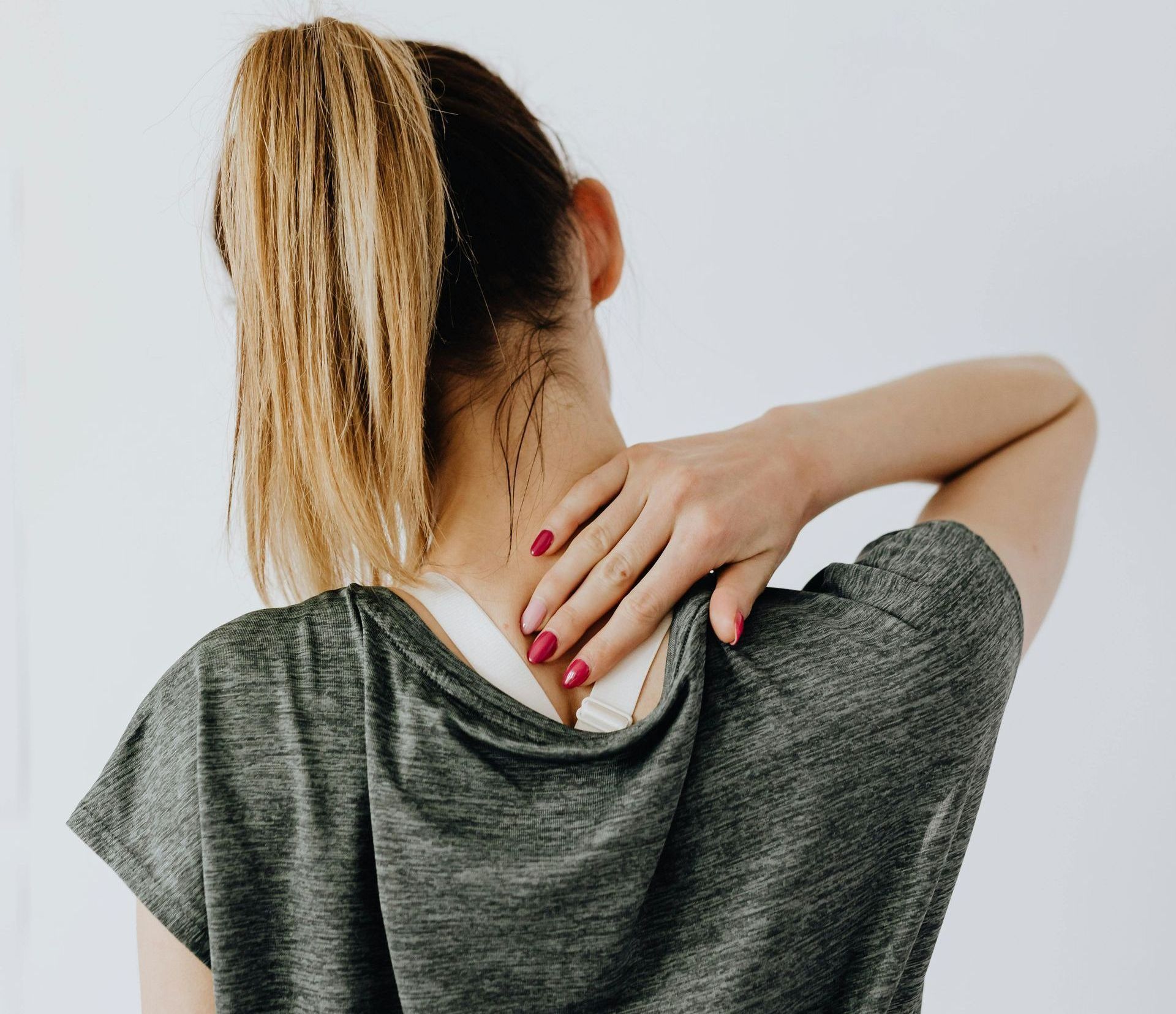 woman holding her neck