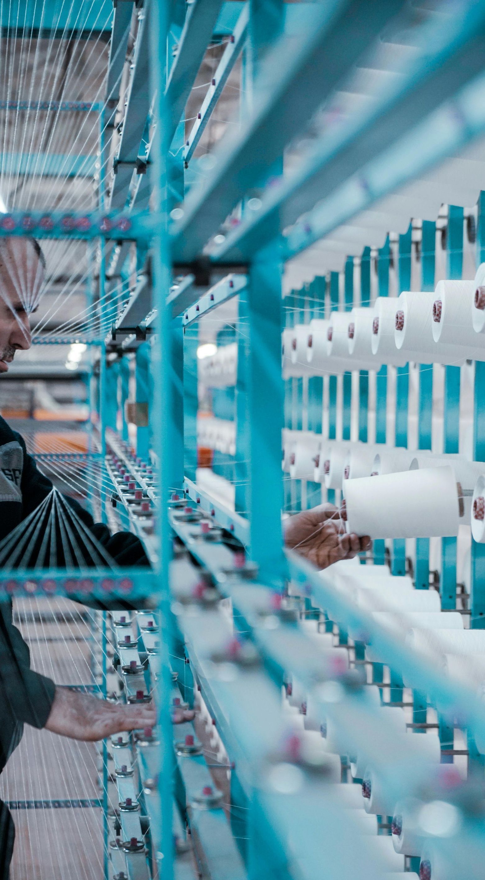 A man is working on a machine in a factory.