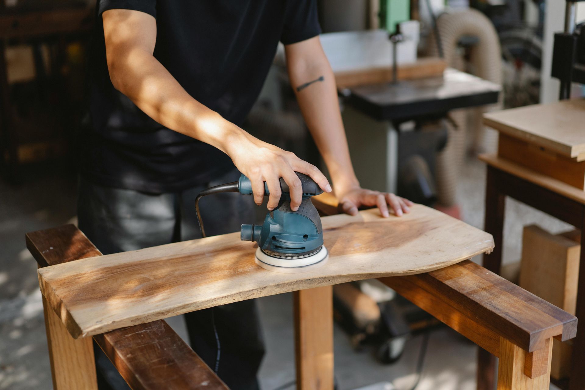 man sanding wood