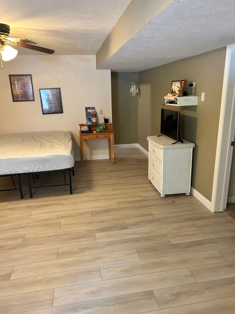 Completed bedroom restoration with new flooring after water damage