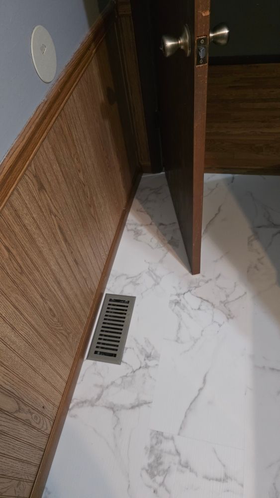 Floor vent detail showing clean finish after bathroom restoration