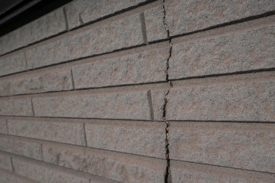Damaged exterior siding showing water intrusion and deterioration
