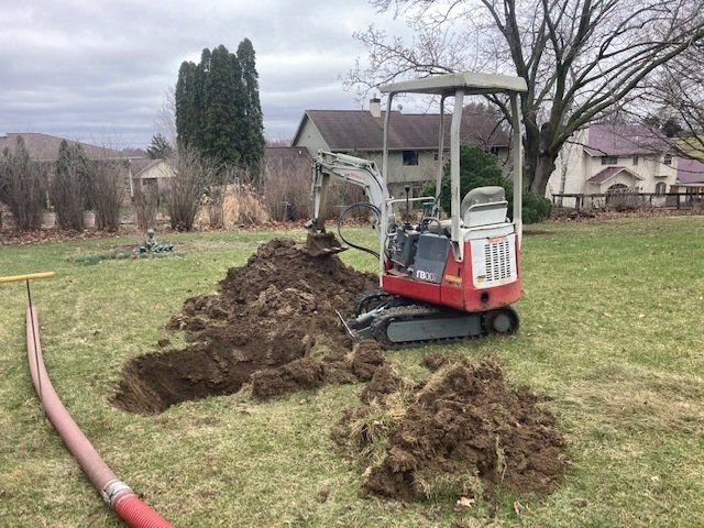 Worker Holding Pipe — Dubuque, IA — Triple J Septic Services Worker Holding Pipe — Dubuque, IA — Triple J Septic Services