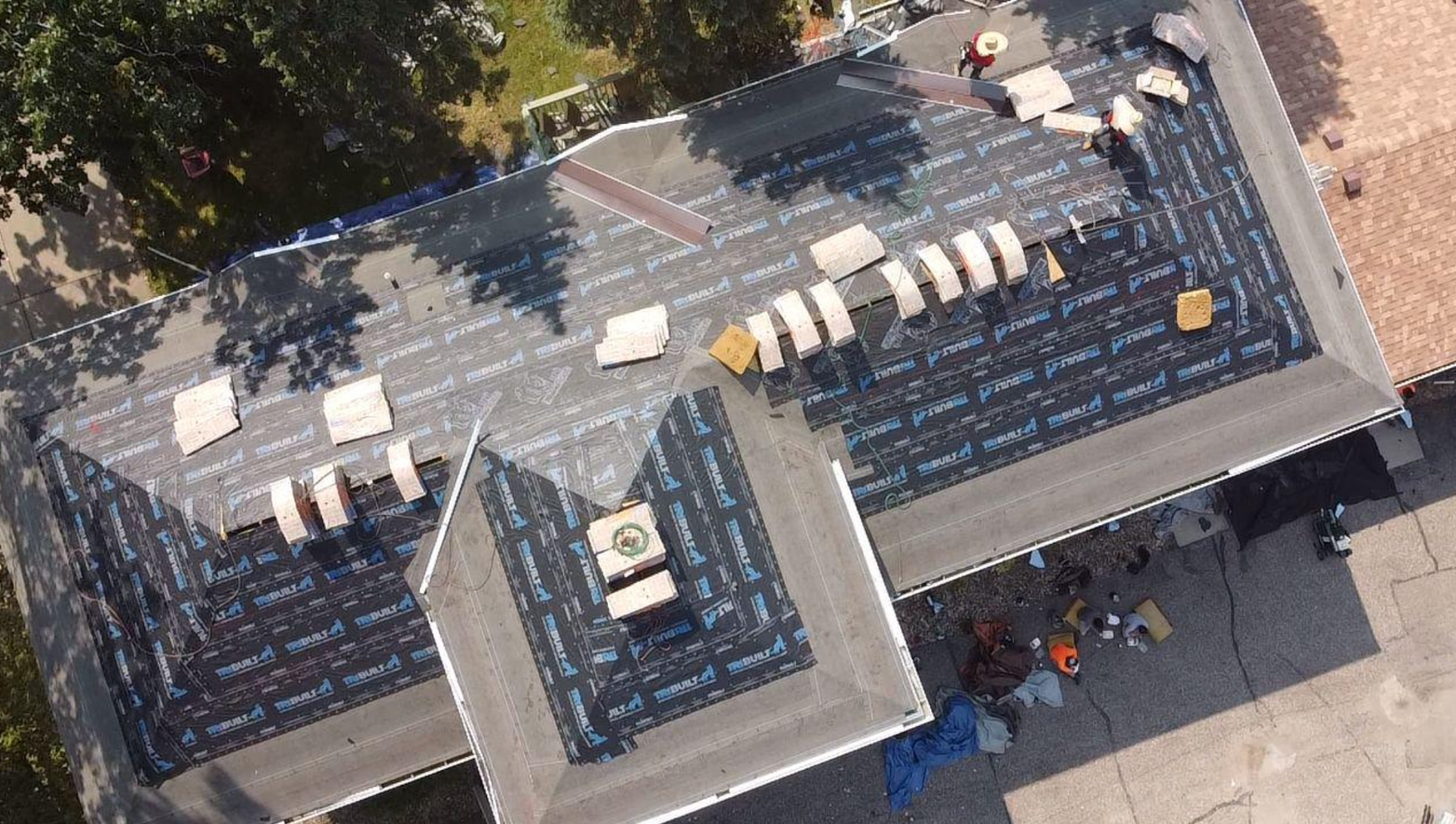 An aerial view of a roof being installed on a house.