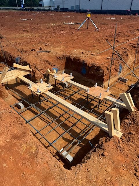 A concrete slab is being built in the dirt