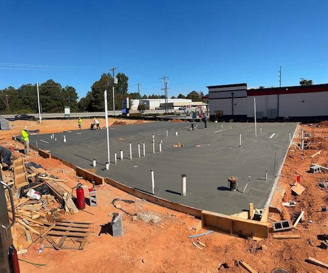 A large concrete base is being built for a building under construction.