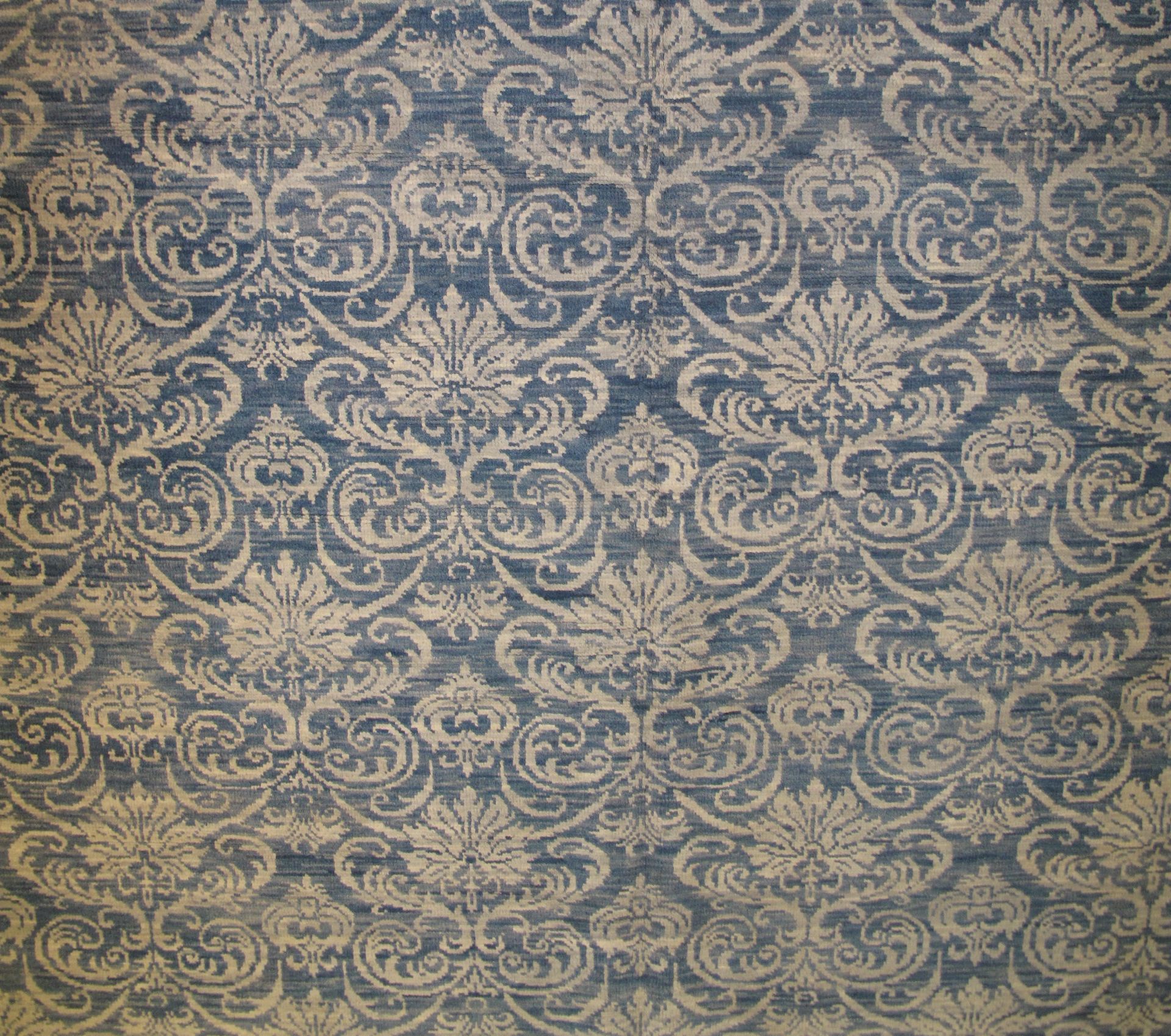 Blue and tan damask patterned rug.