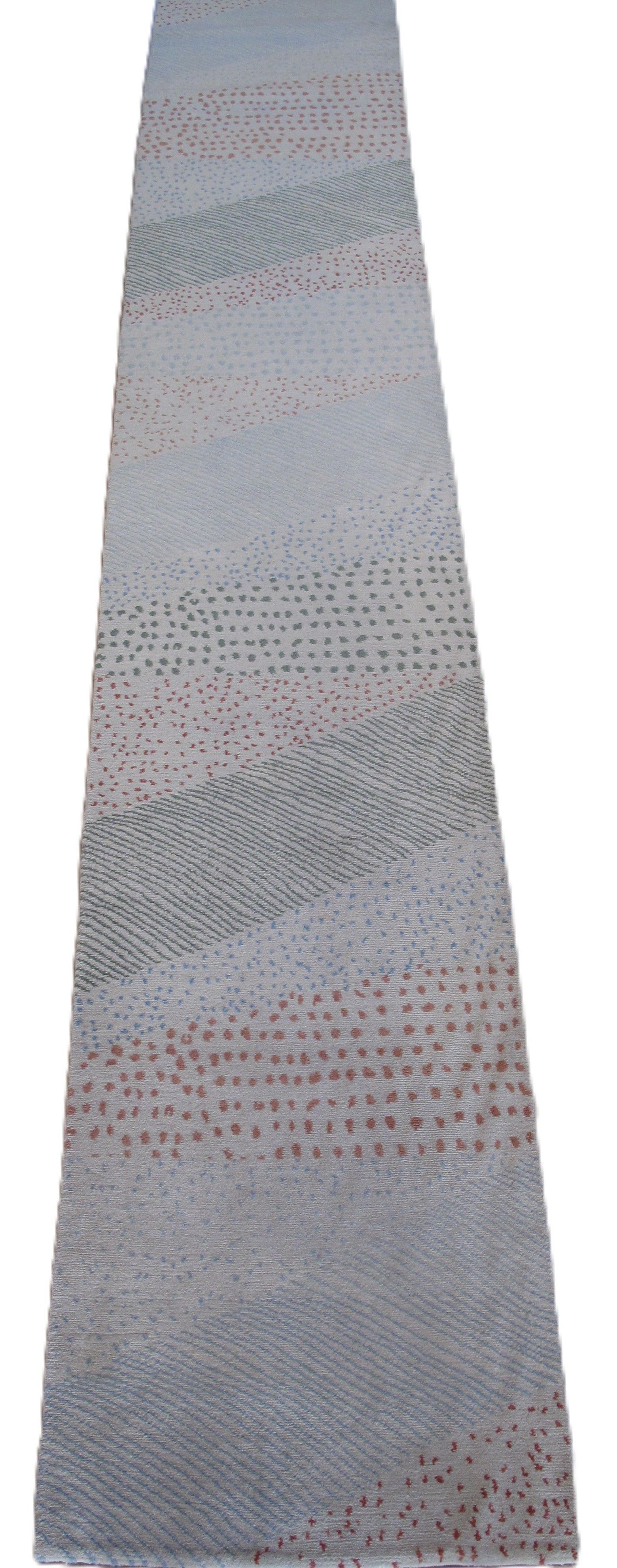 Long, narrow rug with light blue, gray, and brown stripes, and a dotted pattern.