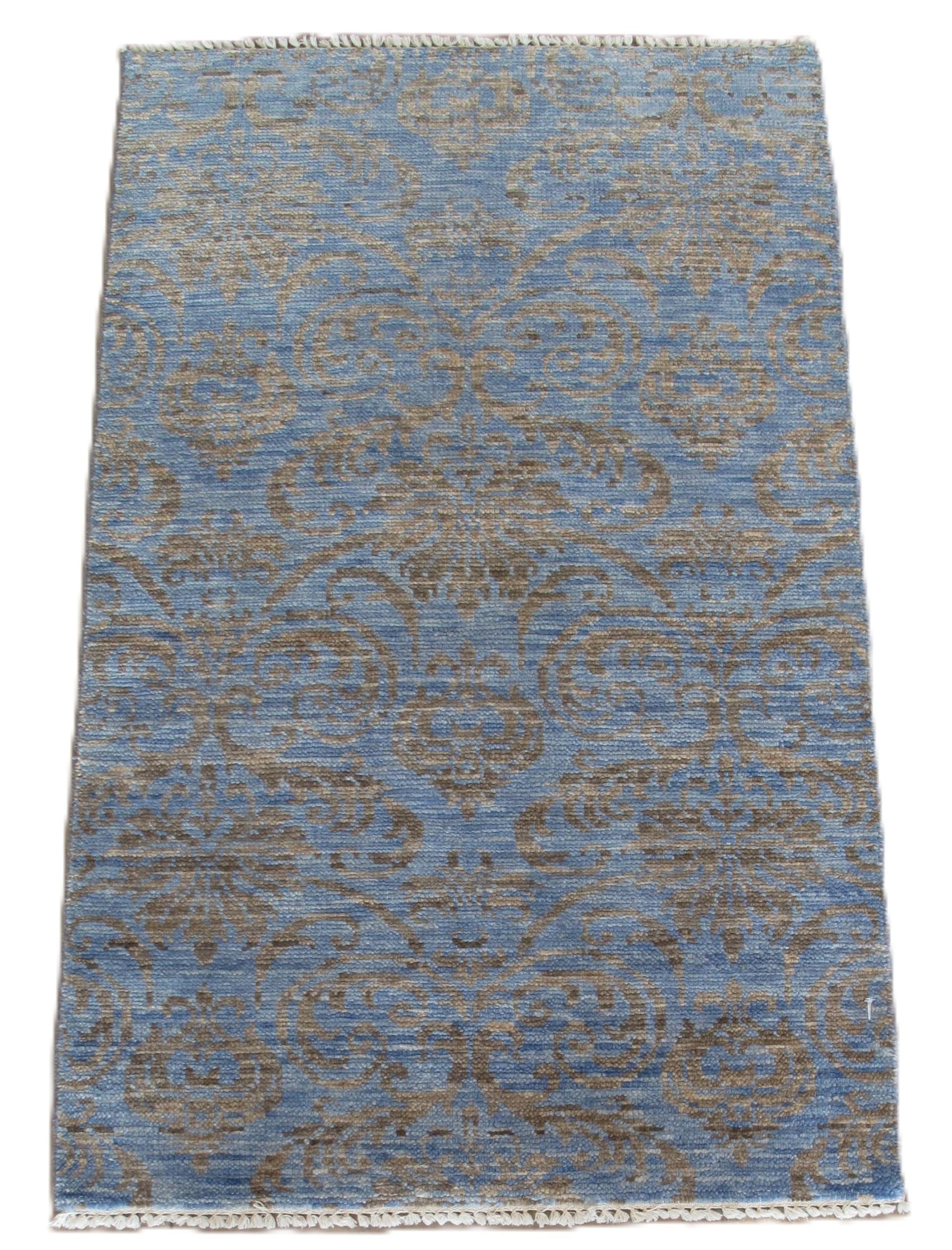 Blue and gray patterned rug on white background.