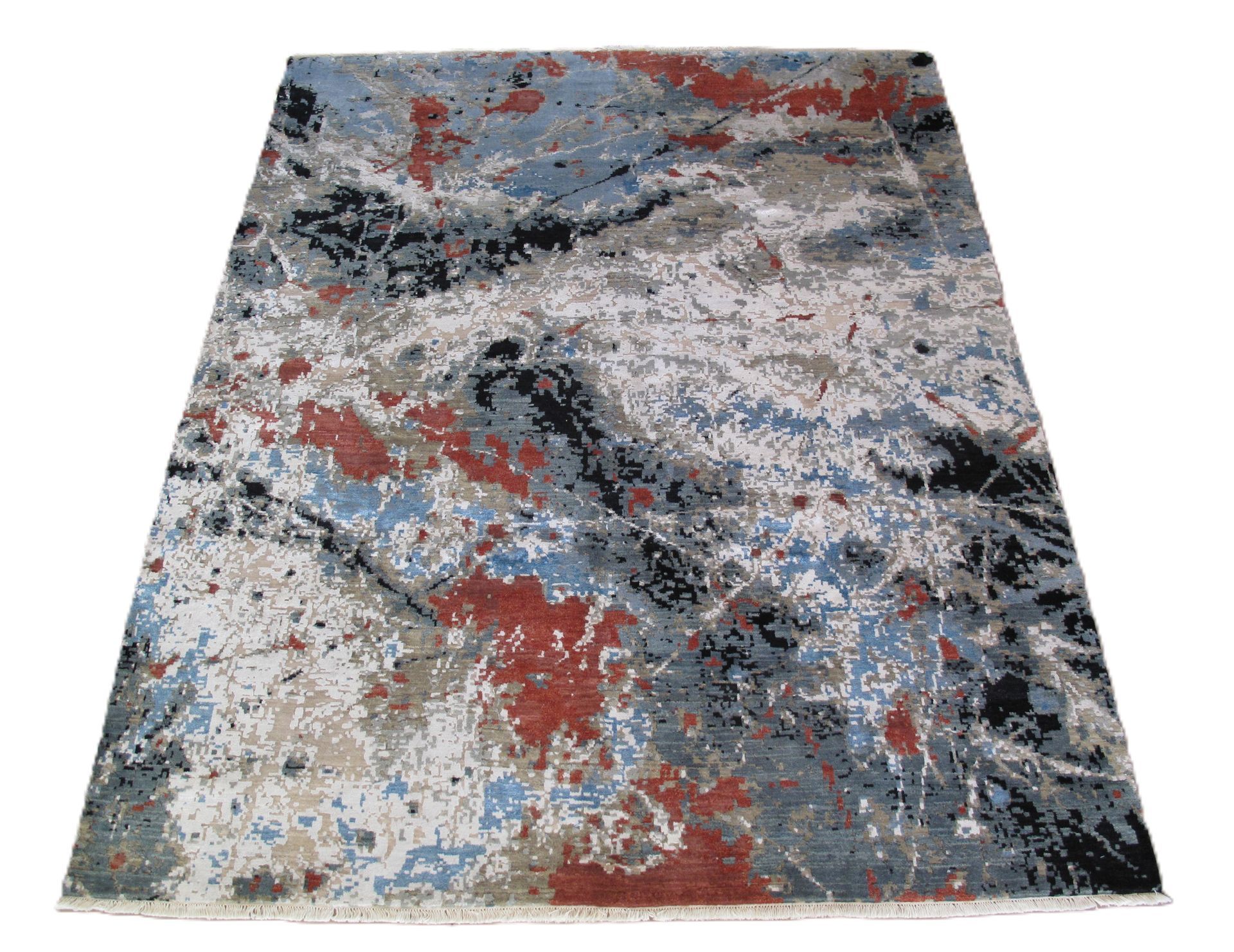 Abstract rug with splotches of blue, red, black, and beige on a white background.