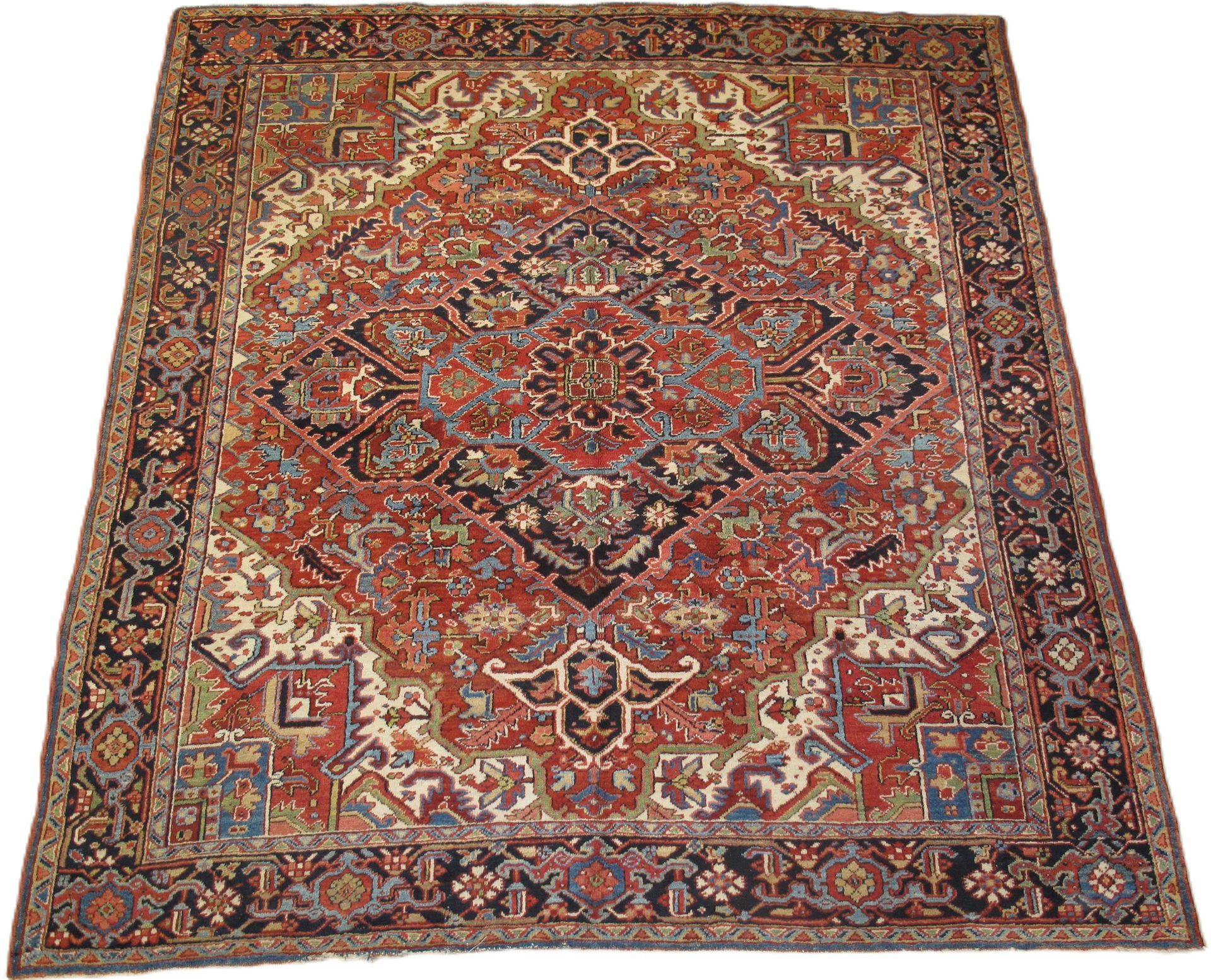 Red, navy, and cream Persian rug with ornate central medallion and border.