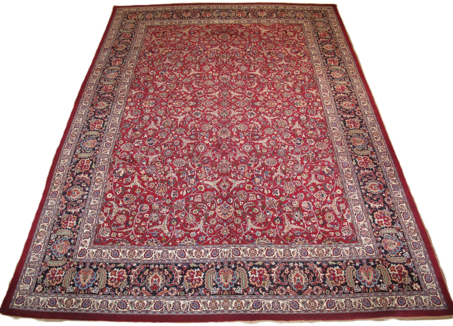 Red Persian rug with floral patterns and ornate border.