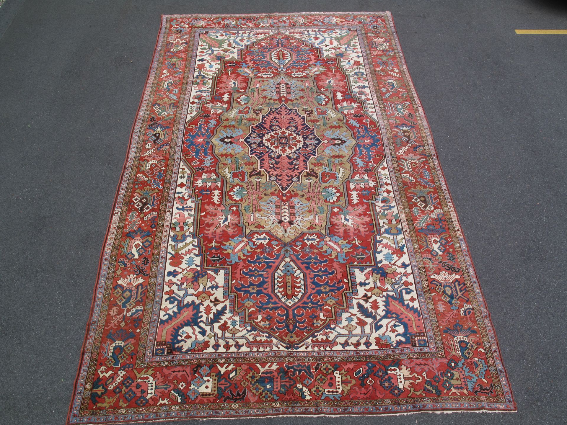 Ornate red and blue Persian-style rug with intricate floral and geometric patterns