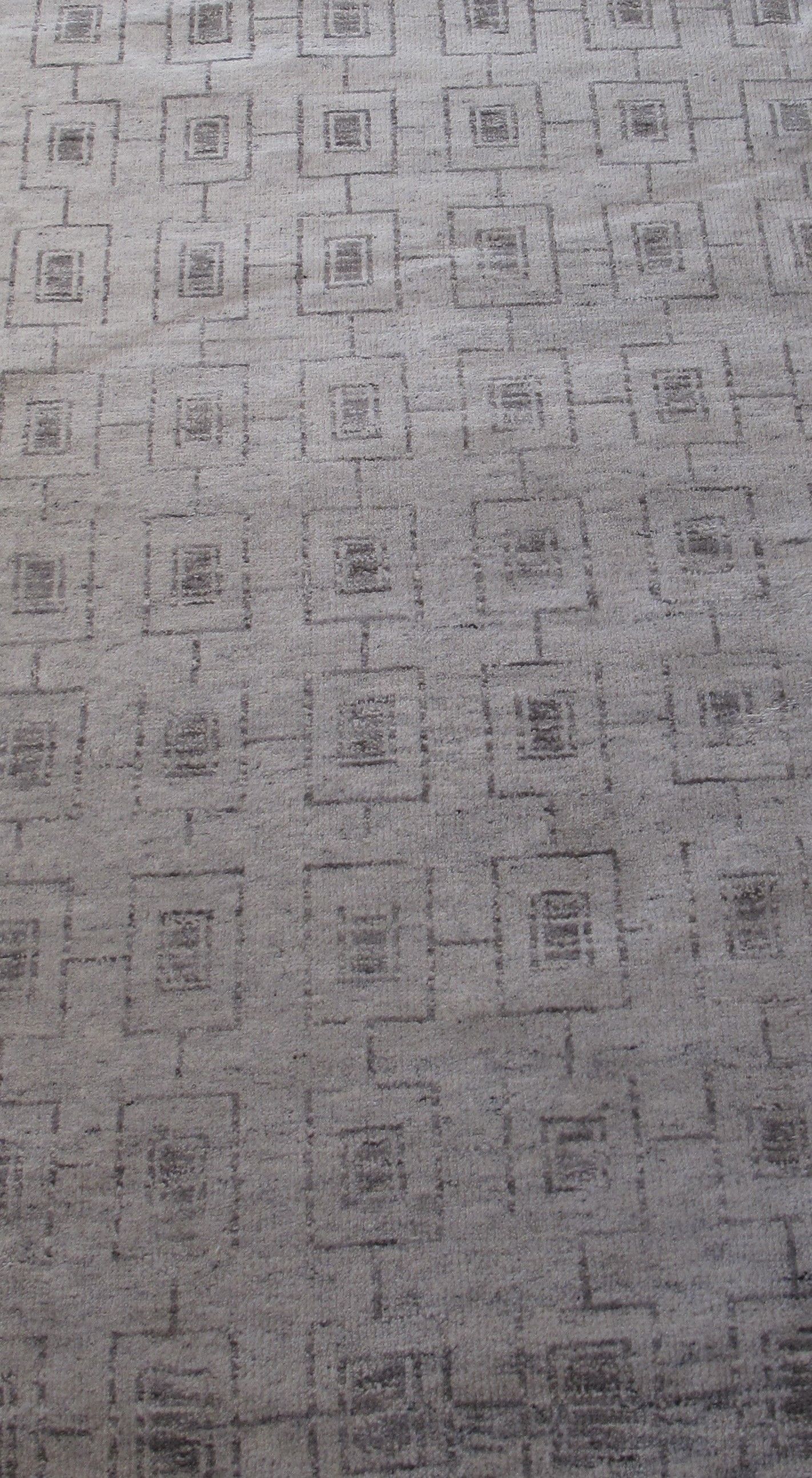 Gray patterned carpet with a repeating geometric square design
