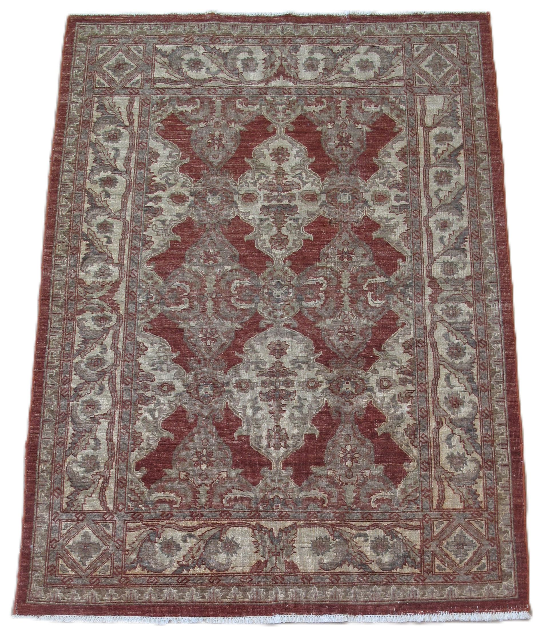 A rectangular rug with a red and beige floral, intricate Persian-style pattern and a decorative border.