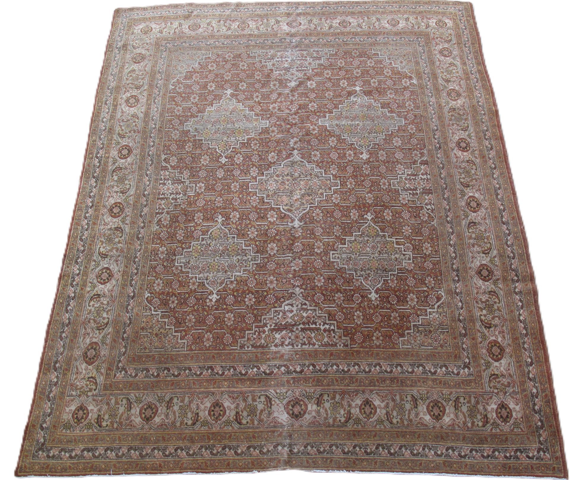 Large, rectangular Persian rug with a brown and cream color palette and ornate central pattern.