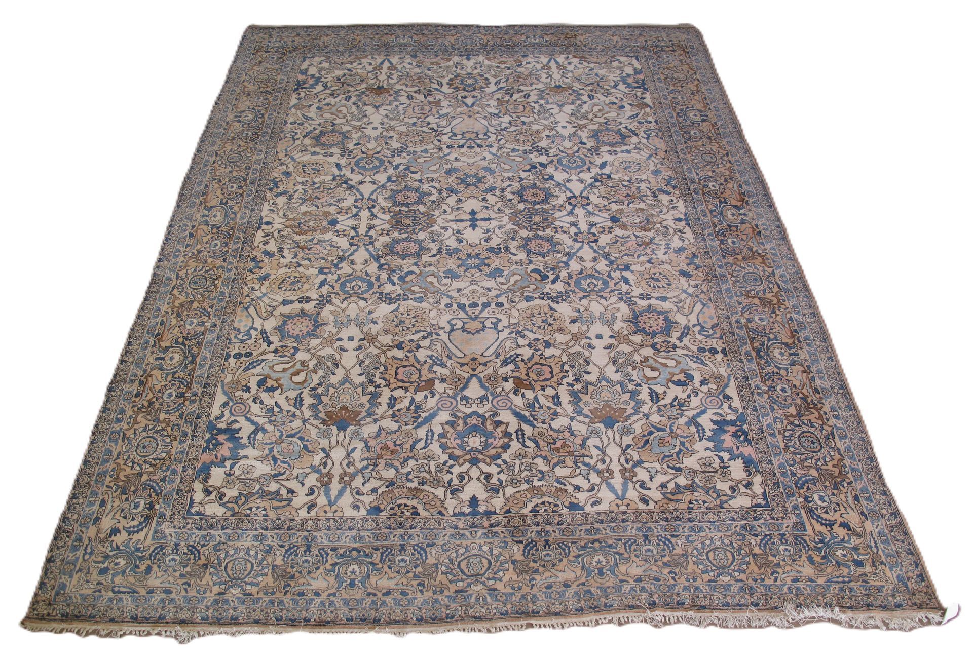 Large rectangular rug with floral patterns in blue, beige, and brown, on a white background.