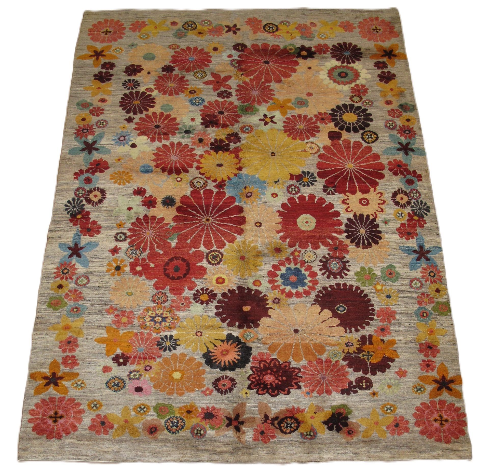 Beige rug with colorful floral pattern.