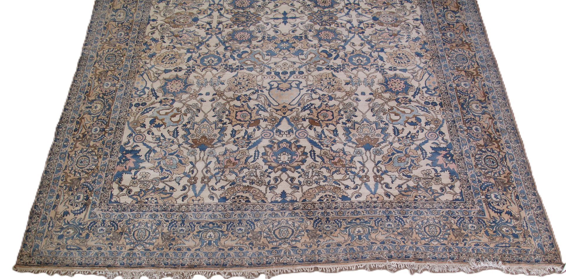 Large rectangular rug with floral patterns in blue, beige, and brown, on a white background.