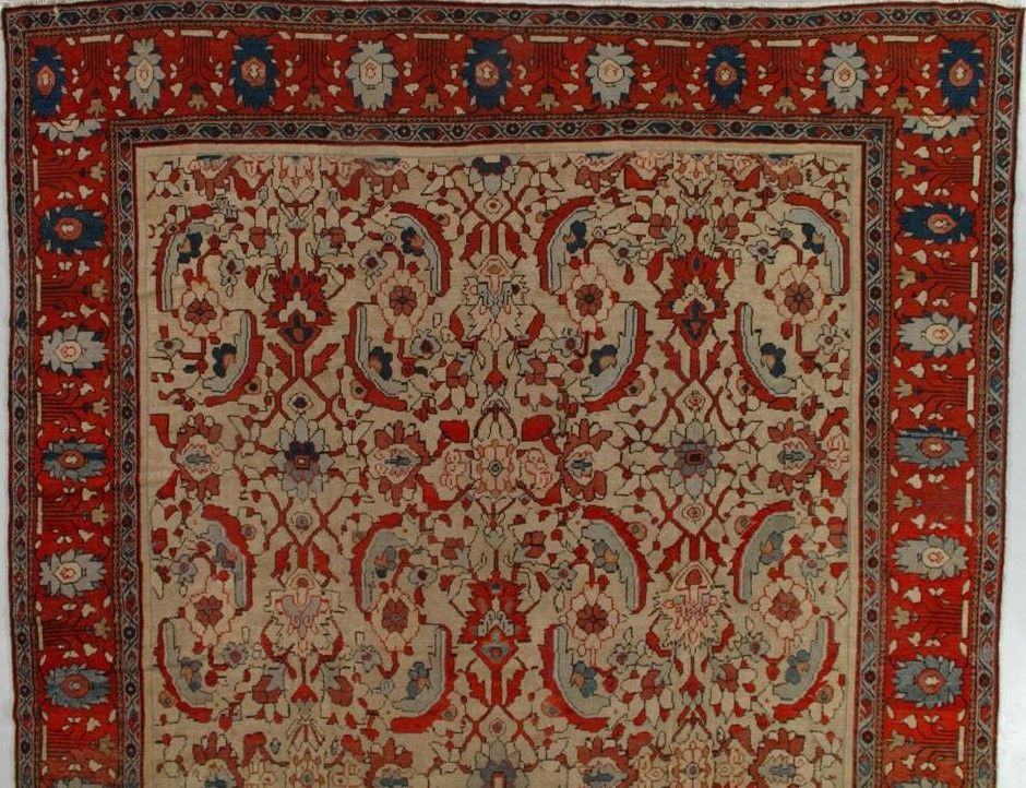 Red, cream, and blue patterned Oriental rug with floral motifs and a red border.