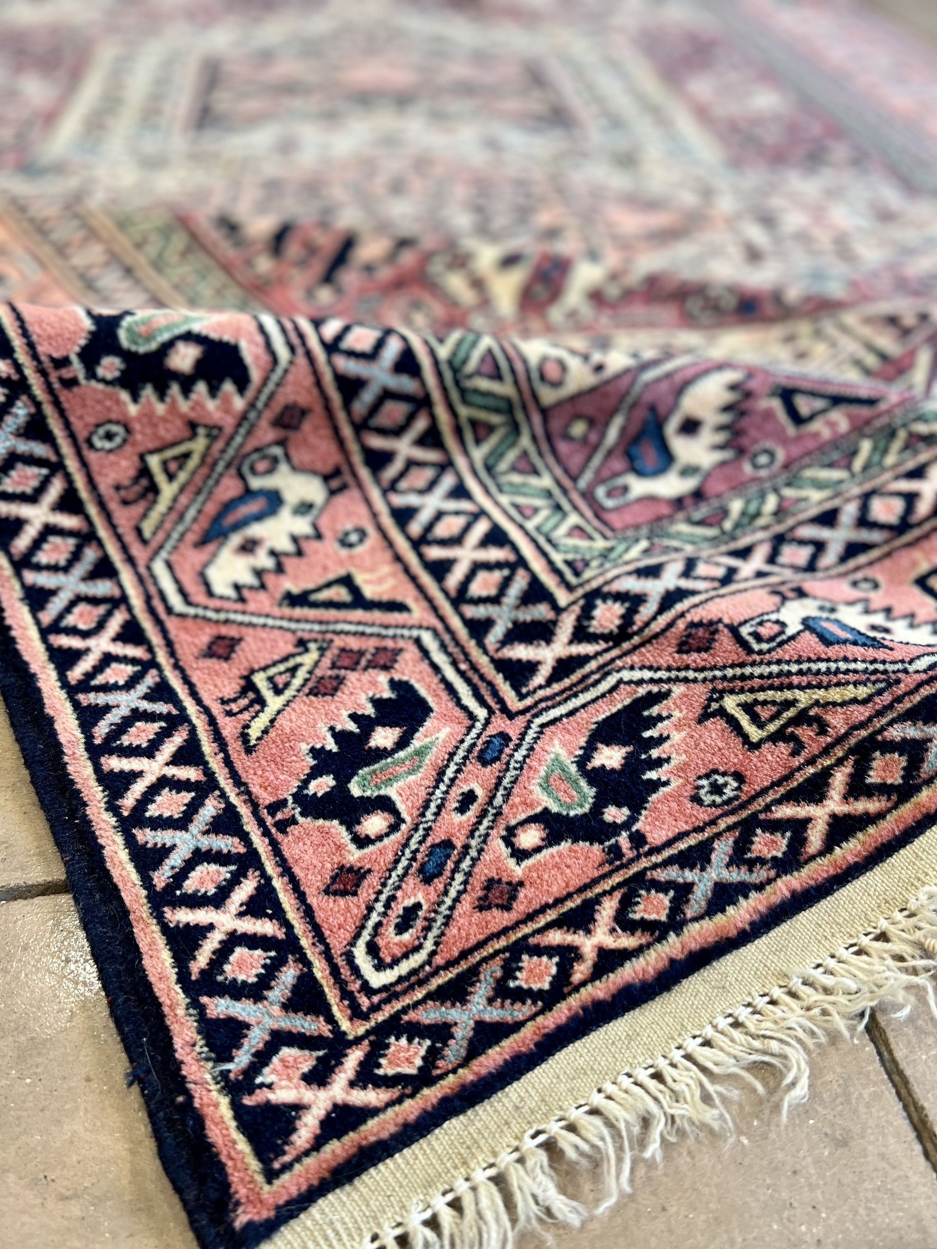 A rug with a floral pattern on it is sitting on a table.