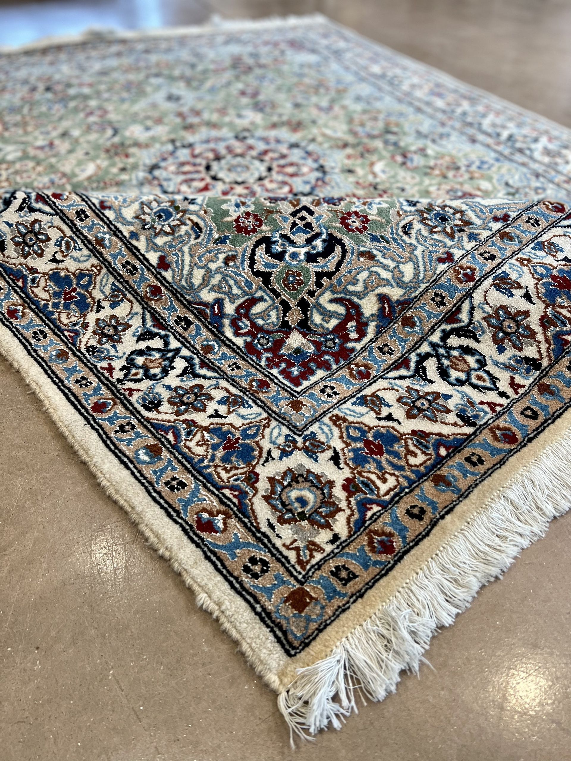 A rug with a floral pattern on it is sitting on a table.