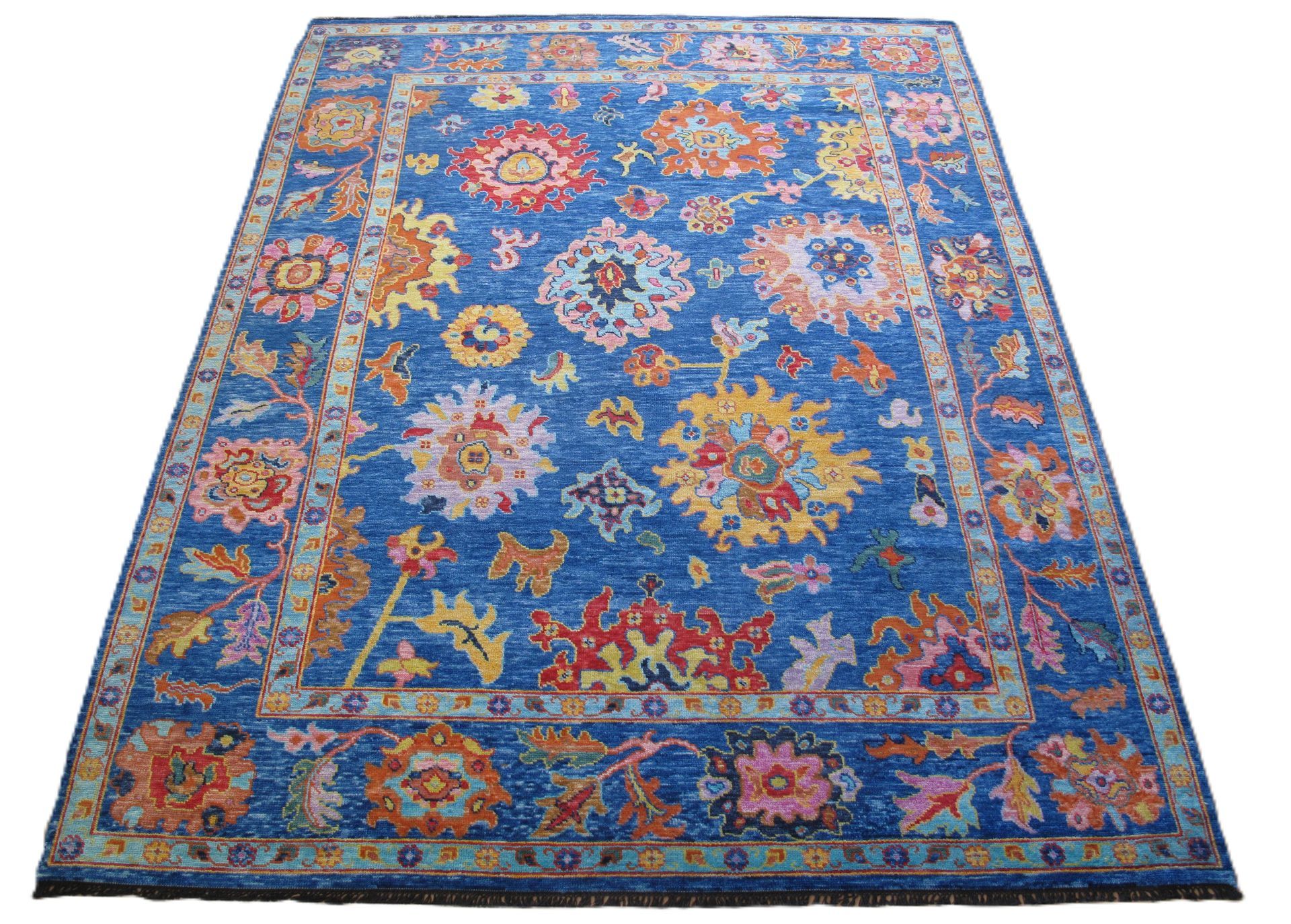 Blue rug with floral pattern, various colors, framed border.