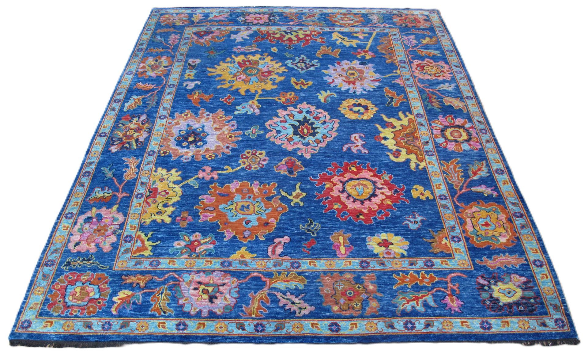 Blue rug with floral pattern, various colors, framed border.