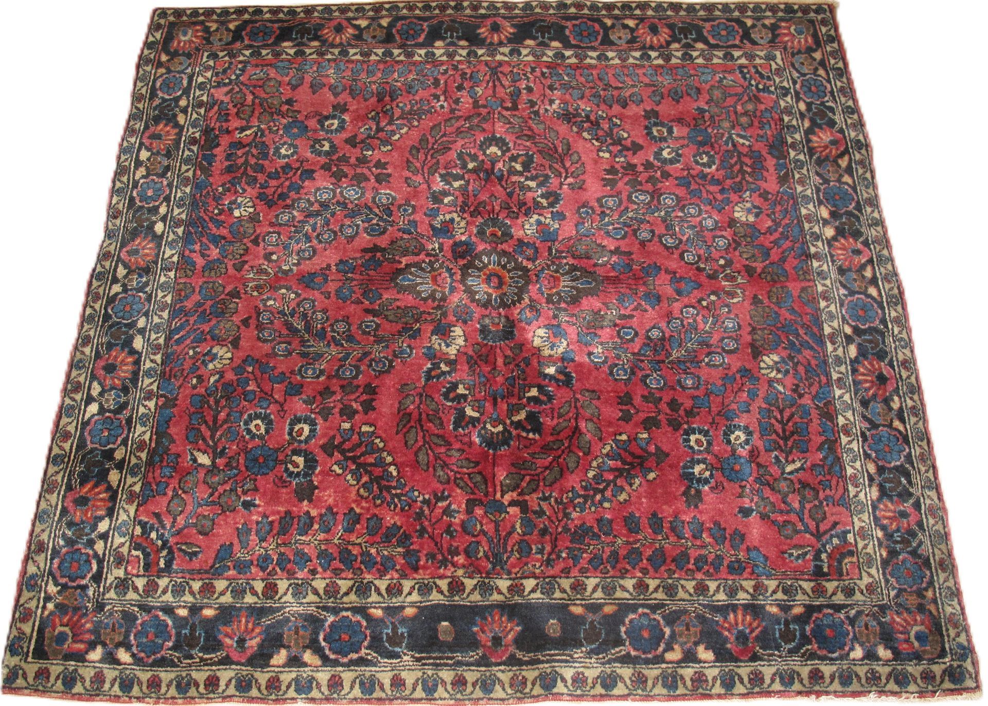 Red and blue oriental rug with intricate floral pattern.