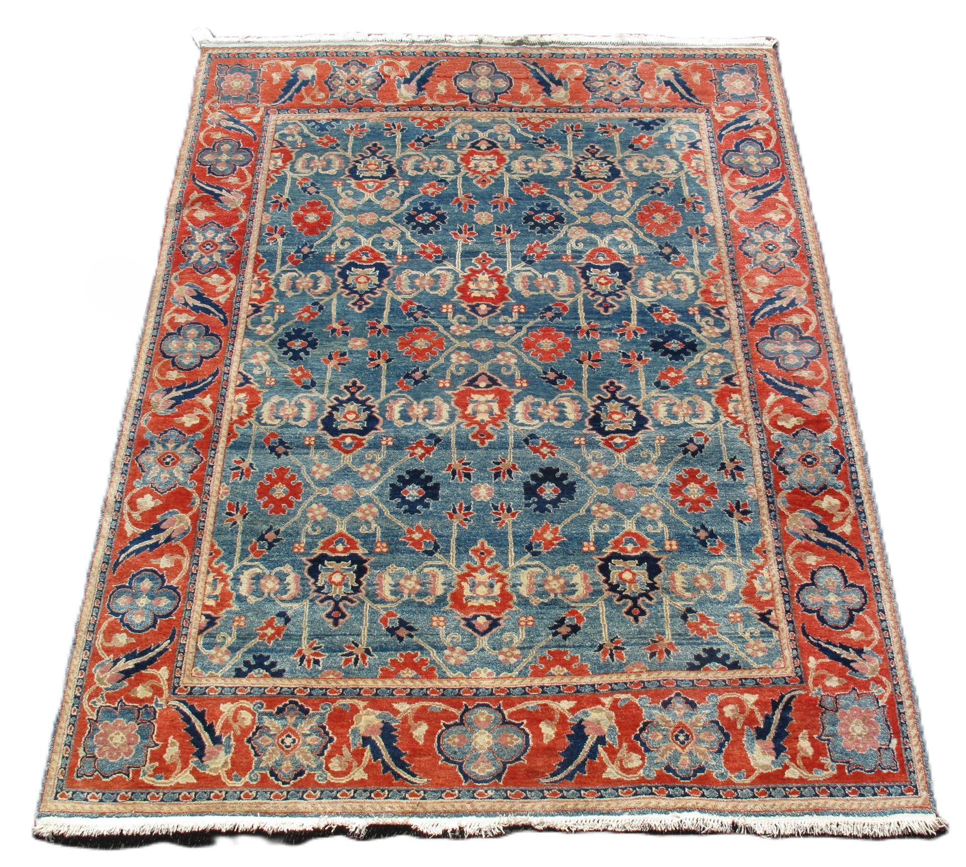 Blue and rust-colored Oriental rug with intricate floral pattern and border.