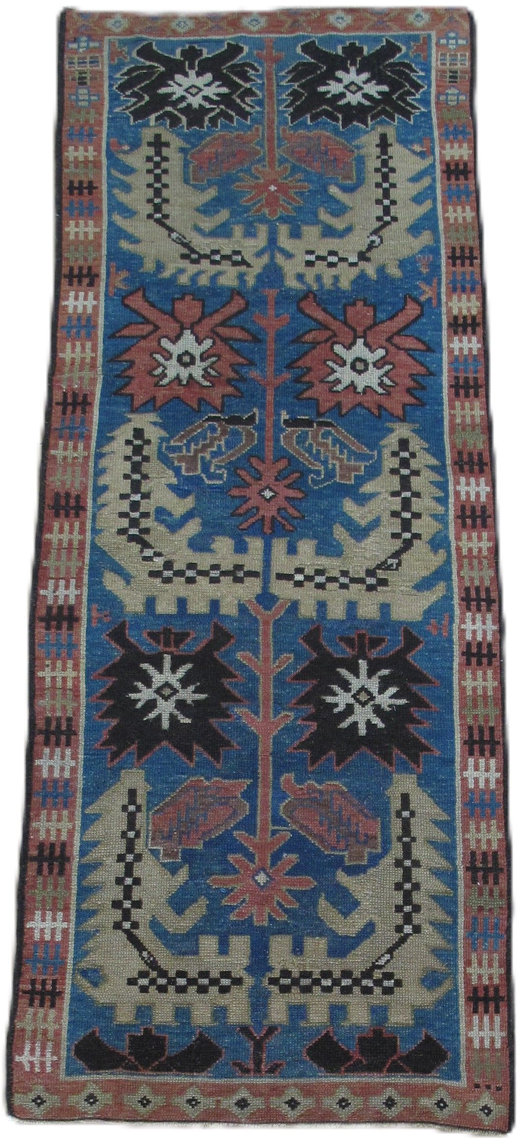Blue, patterned rug with floral motifs and a brown border.
